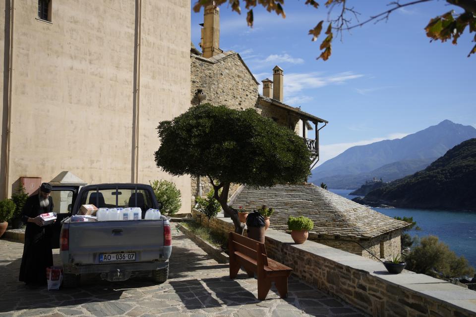 A monk unload supplies for the Pantokrator Monastery in the Mount Athos, northern Greece, on Thursday, Oct. 13, 2022. The monastic community was first granted self-governance through a decree by Byzantine Emperor Basil II, in 883 AD. Throughout its history, women have been forbidden from entering, a ban that still stands. This rule is called "avaton" and the researchers believe that it concerns every form of disturbance that could affect Mt. Athos. (AP Photo/Thanassis Stavrakis)