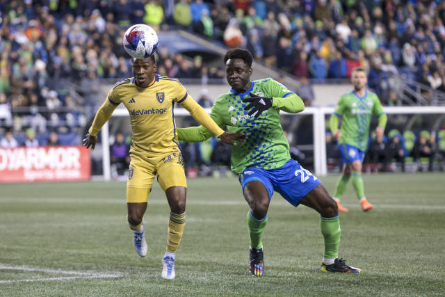 Real Salt Lake midfielder Anderson Julio, left, and Seattle Sounders defender Yeimar Gomez compete for the ball during the first half of an MLS soccer match Saturday, March 4, 2023, in Seattle. (AP Photo/Jason Redmond)