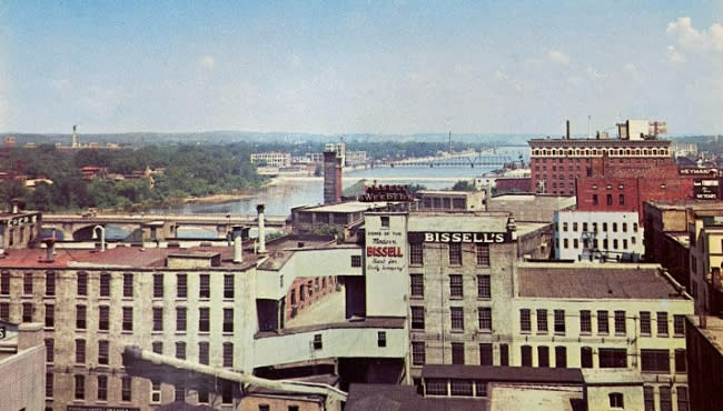 A 1978 postcard shows an aerial view of the old Bissell plant on the Grand River in downtown Grand Rapids. (GRPL Local History Archives)