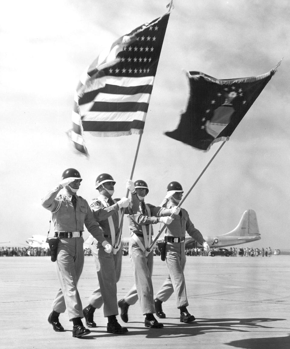 An Air Force Honor Guard parades the colors during a 1957 airshow at Dyess Air Force Base.