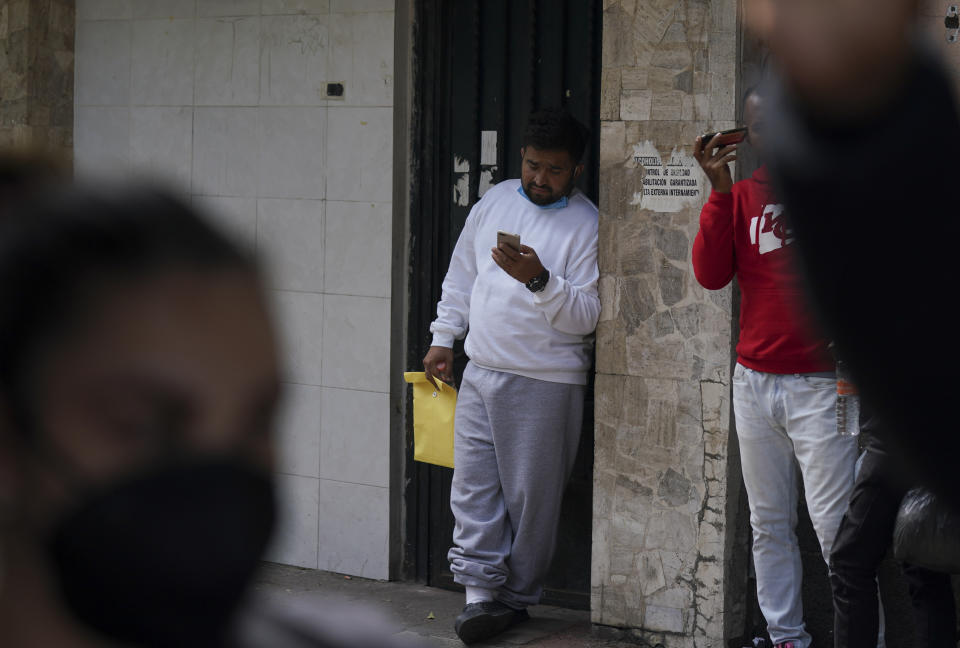 Venezuelan migrants seek for assistance outside of the Mexican Commission for Refugee Aid in Mexico City, Thursday, Oct. 20, 2022. These Venezuelan migrants were returned to Mexico by U.S. immigration authorities after crossing the border last week. (AP Photo/Fernando Llano)