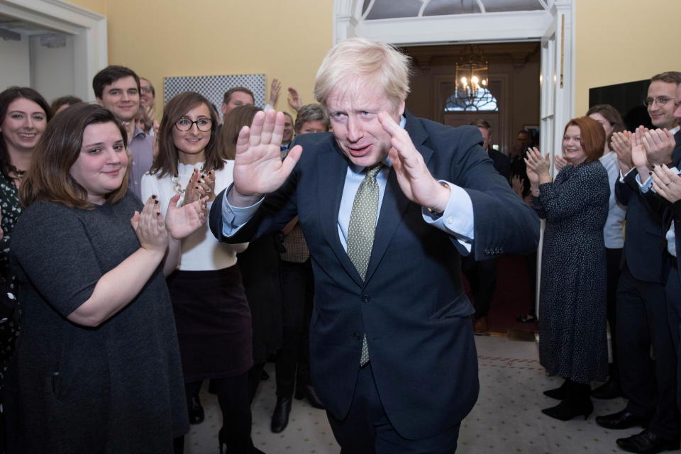 Britain's Prime Minister Boris Johnson reacts as he is greeted by staff, arriving back at Downing Street, after meeting Queen Elizabeth and accepting her invitation to form a new government, in London, Britain December 13, 2019. Stefan Rousseau/Pool via REUTERS