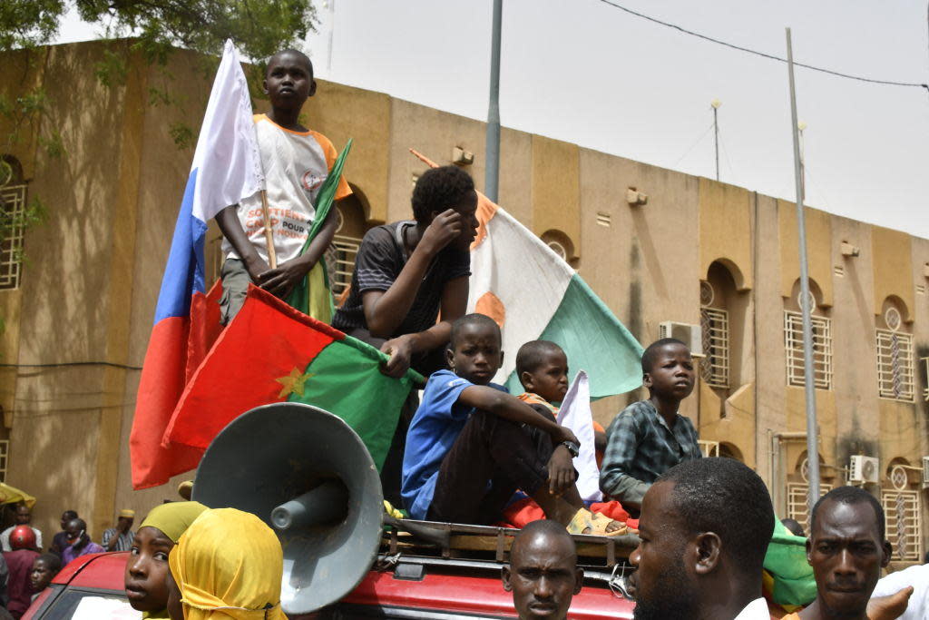 Boys gather on top of a car while displaying flags of Niger, Burkina Faso and Russia during a demonstration demanding the immediate departure of U.S. troops from Niger, in Niamey, April 13, 2024. / Credit: AFP/Getty