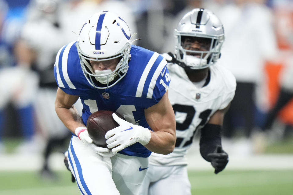 Indianapolis Colts wide receiver Alec Pierce, left, makes a touchdown catch past Las Vegas Raiders cornerback Amik Robertson (21) during the first half of an NFL football game Sunday, Dec. 31, 2023, in Indianapolis. (AP Photo/AJ Mast)
