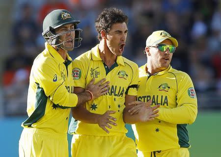 Australia Mitchell Starc (C) celebrates with teammates Aaron Finch (R) and Glenn Maxwell (L) after bowling out New Zealand's Grant Elliott during their Cricket World Cup match in Auckland, February 28, 2015. REUTERS/Nigel Marple