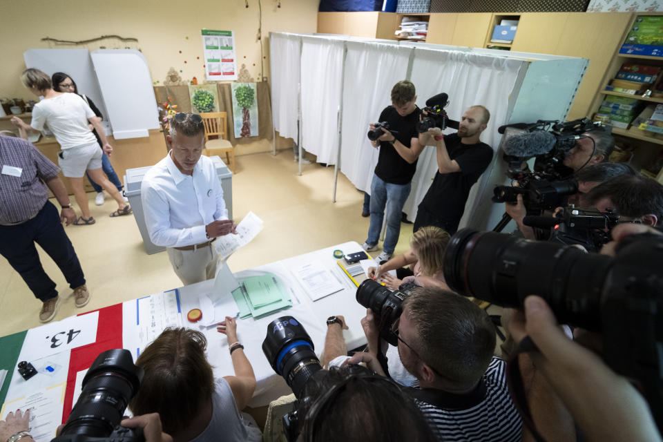 Political newcomer Péter Magyar receives his ballot papers at a polling station during European Parliamentary elections in Budapest, Hungary, Sunday, June 9, 2024. Polling stations have opened across Europe as voters from 20 countries cast ballots in elections that are expected to shift the European Union’s parliament to the right and could reshape the future direction of the world’s biggest trading bloc. (AP Photo/Denes Erdos)