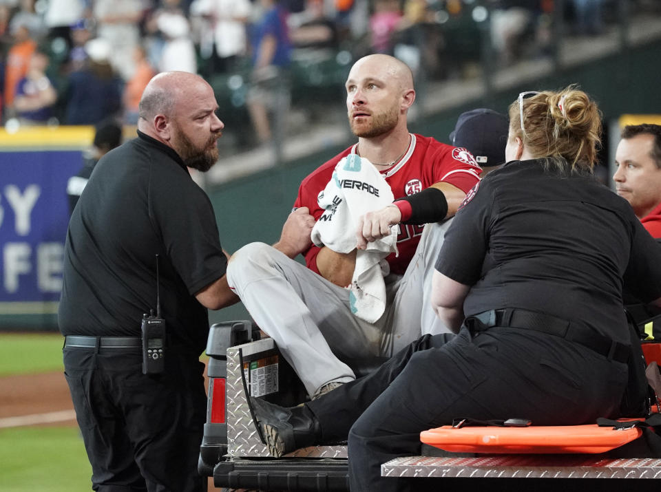 Los Angeles Angels' Jonathan Lucroy, center, is carted off the field after colliding with Houston Astros' Jake Marisnick at home plate during the eighth inning of a baseball game Sunday, July 7, 2019, in Houston. (AP Photo/David J. Phillip)