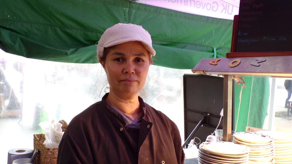 A woman at a street food stall in Chelmsford Market