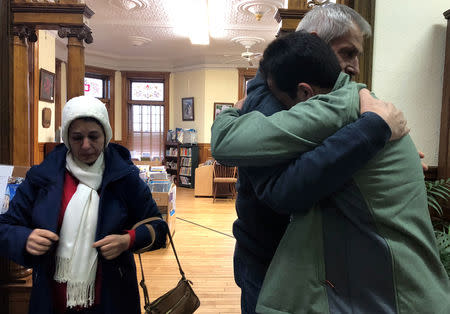 An Iranian man, a student in the United States, embraces his father as they say goodbye at the Haskell Free Library and Opera House, which straddles the U.S.-Canada border in Stanstead, Quebec and in Derby Line, Vermont, U.S., November 3, 2018. Picture taken November 3, 2018. REUTERS/Yeganeh Torbati