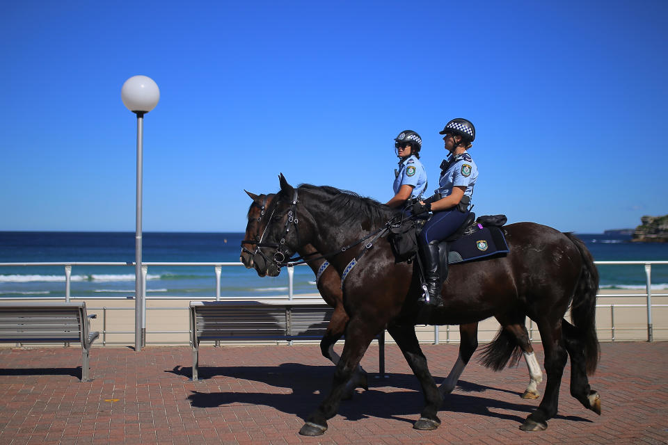 Police on horses enforce social distancing regulations to slow the spread of coronavirus disease at Bondi Beach in Sydney on April 4, 2020. Source: AAP