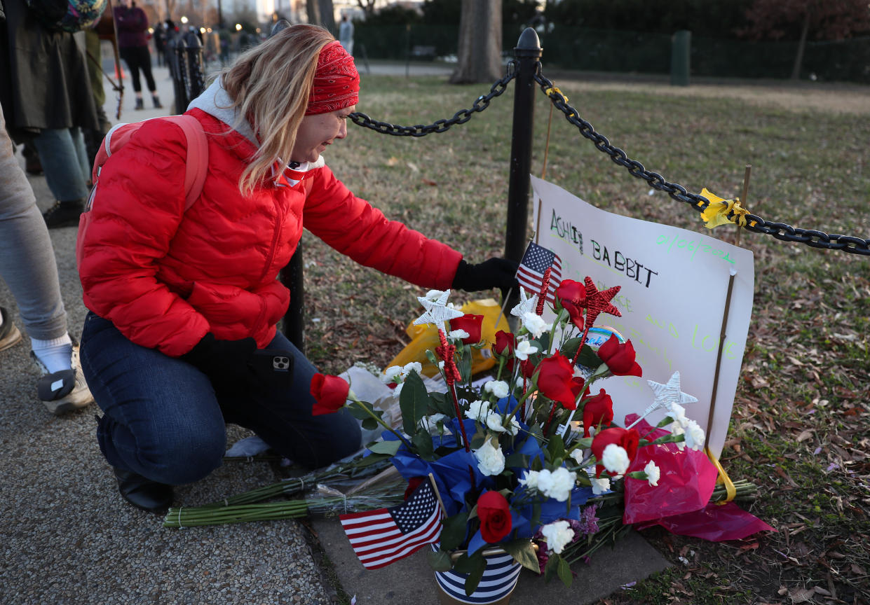 Melody Black, from Minnesota, becomes emotional while visiting a memorial setup near the U.S. Capitol Building for Ashli Babbitt on Jan. 7, 2021. Babbitt was killed after she and a pro-Trump mob broke into the building on Jan. 6.  (Joe Raedle/Getty Images)