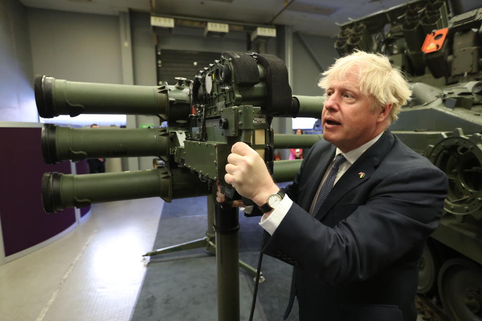 Britain's Prime Minister Boris Johnson with a Mark 3 shoulder launch LML (Lightweight Multiple Launcher) missile system at Thales weapons manufacturer in Belfast, Monday May 16, 2022, during a visit to Northern Ireland. Johnson said there would be “a necessity to act” if the EU doesn't agree to overhaul post-Brexit trade rules that he says are destabilizing Northern Ireland's delicate political balance. Johnson held private talks with the leaders of Northern Ireland's main political parties, urging them to get back to work. (Liam McBurney/Pool via AP)