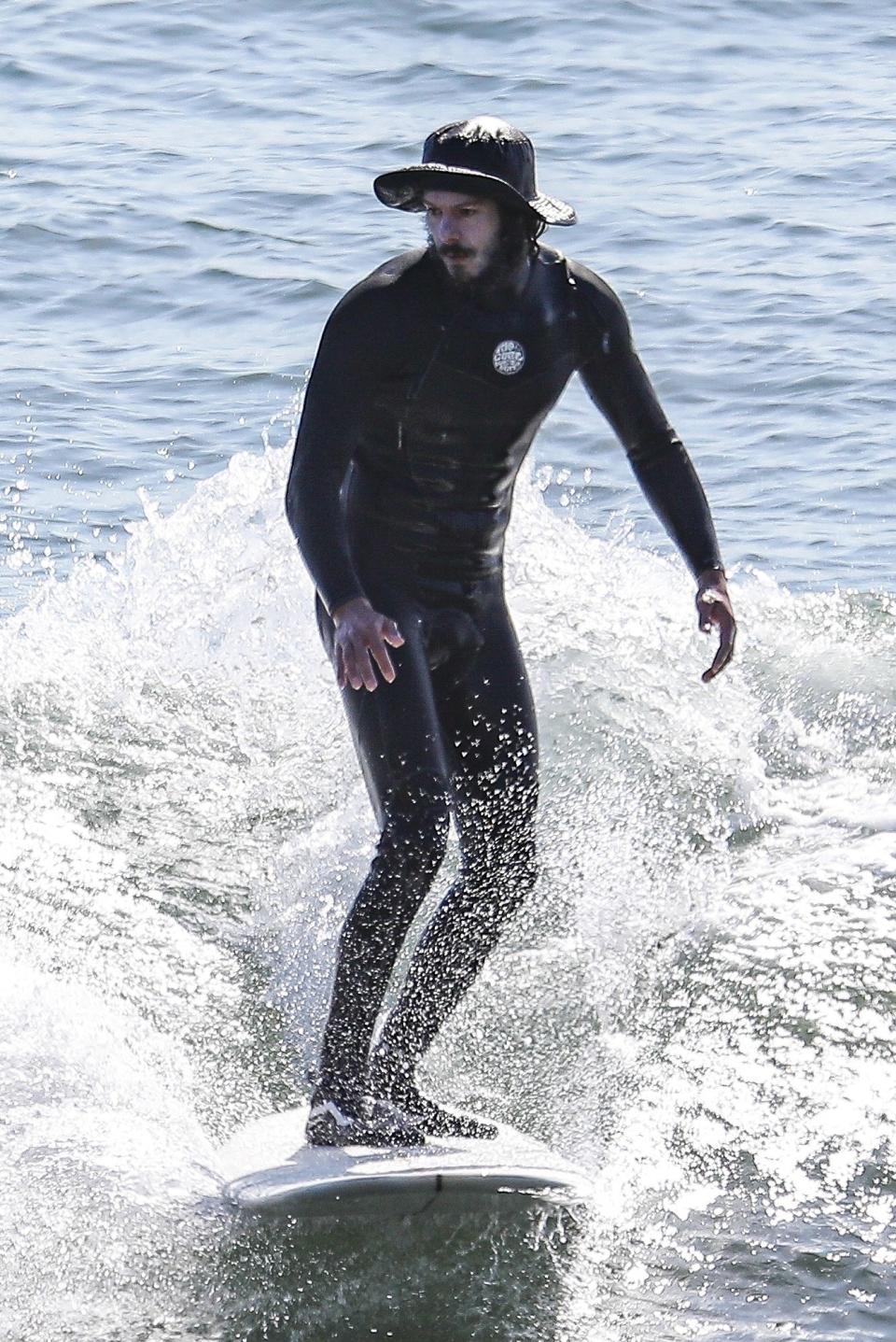 Adam Brody surfing in Malibu, November 12, 2020.