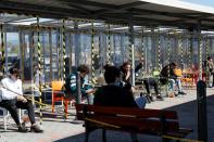 Workers relax during a break outside Amazon's distribution centre in Passo Corese