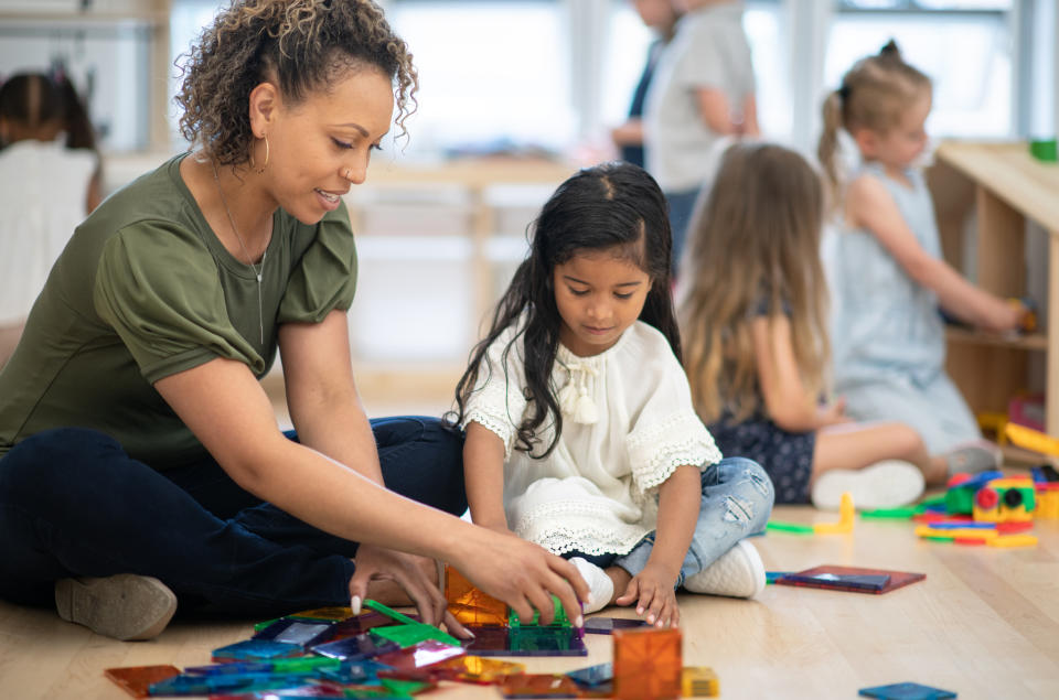 A teacher working with a student