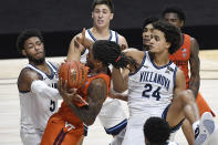 Virginia Tech's Cartier Diarra is fouled by Villanova's Justin Moore, left, as Villanova's Jeremiah Robinson-Earl, right, defends during the second half of an NCAA college basketball game Saturday, Nov. 28, 2020, in Uncasville, Conn. (AP Photo/Jessica Hill)