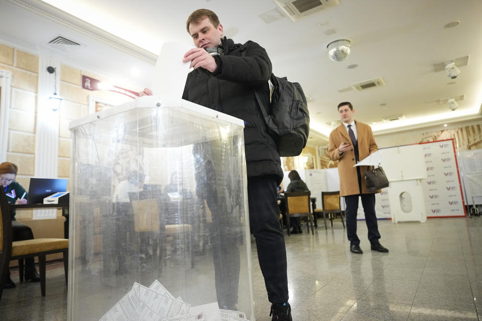 A voter casts a ballot during a presidential election in Moscow, Russia, Friday, March 15, 2024. Voters in Russia are heading to the polls for a presidential election that is all but certain to extend President Vladimir Putin's rule after he clamped down on dissent. (AP Photo/Alexander Zemlianichenko)