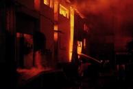 Pakistani firefighters battle a fire at a garment factory in Karachi September 11. Shouting and sobbing relatives of trapped workers, desperate to get inside the factory, scuffled with police overnight as rescuers battled to work through the night, an AFP photographer said