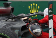 Mercedes driver Lewis Hamilton of Britain, left, is congratulated by Ferrari driver Sebastian Vettel of Germany after winning the race and the world championship after the Turkish Formula One Grand Prix at the Istanbul Park circuit racetrack in Istanbul, Sunday, Nov. 15, 2020. (Murad Sezer/Pool via AP)