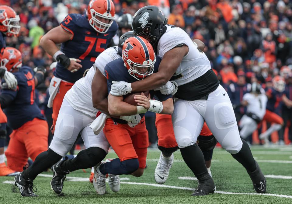 Mo Omonode #92 and Prince James Boyd Jr. #93 of the Purdue Boilermakers sack Tommy DeVito #3 of the Illinois Fighting Illini during the first half Saturday, Nov. 12.