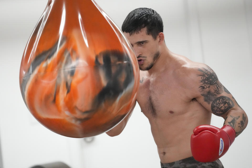 Biaggio Ali Walsh hits a punching bag while training Monday, July 24, 2023, in New York. Ali Walsh used to think about fighting only when kids would find out he was Muhammad Ali's grandson and challenge him to put on the gloves. Now Ali Walsh can't wait to fight, and gets the next chance in his young MMA career Wednesday, Aug. 23 on a Professional Fighters League card at Madison Square Garden, where his grandfather participated in some major events. (AP Photo/Mary Altaffer)