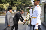 German Defense Minister Boris Pistorius, center, lays a wreath as Indonesian Defense Minister Prabowo Subianto. Left. Looks on during their meeting in Jakarta, Indonesia, Monday, June 5, 2023. (AP Photo/Dita Alangkara)