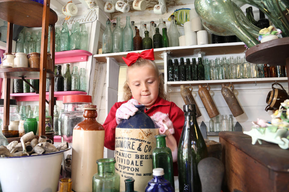 A seven-year-old schoolgirl is raking in hundreds of pounds by selling antique bottles from a little shop in her back garden - after digging them up from old landfill sites. Betsy-Mae Lloyd has been coining it in after launching her own business at her parents' home while still attending primary school.  The young entrepreneur flogs old bottles, jars and teapots - dating back to between the 1870s and 1930 - which she finds on historic landfill sites in the West Midlands.  After taking them home and cleaning them up herself, she then stores them in a Victorian-style play shed, built by dad Jason, before listing them for sale on Facebook. 