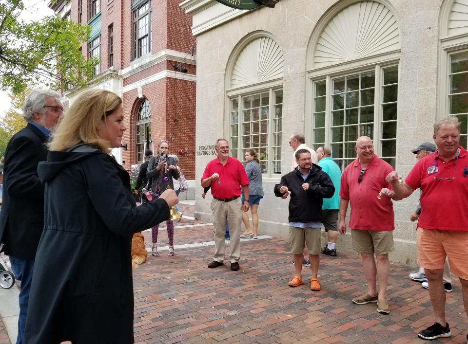 A crowd gathered for the Portsmouth Peace Treaty  Day ceremony rings bells in Market Square in Portsmouth on Sept. 5, 2021.