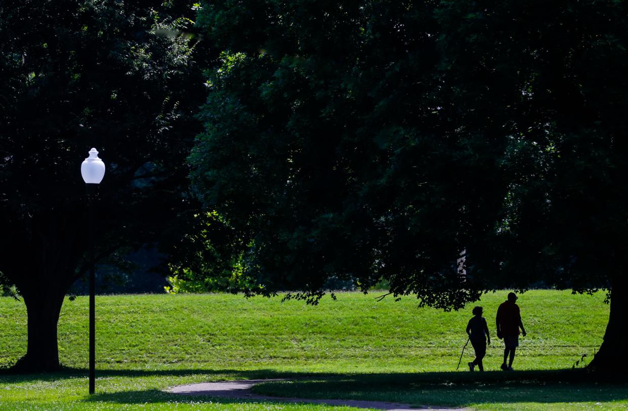 A couple walks in Chickasaw Park on Monday morning, June 26, 2023. The park was designed by the Frederick Law Olmsted firm from the former country estate of John Henry Whallen. The park was one of the few Black-only park before being desegregated in 1955. The park has 61 acres and has clay tennis courts, basketball court, a spray ground, lodge and two picnic pavilions.