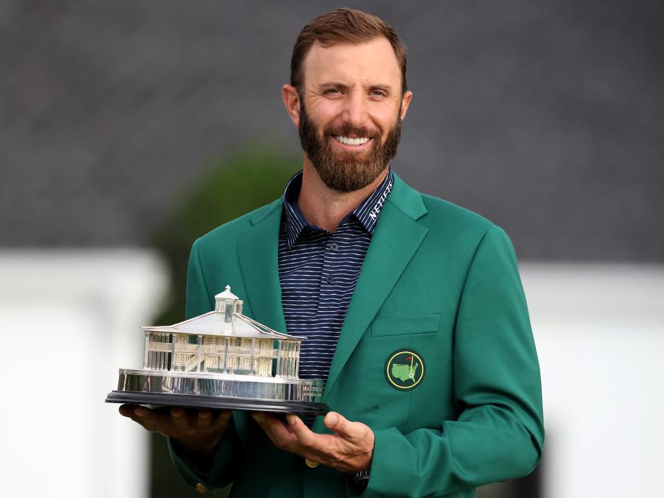 <p>Dustin Johnson poses with the trophy at August in 2020</p> (Getty Images)