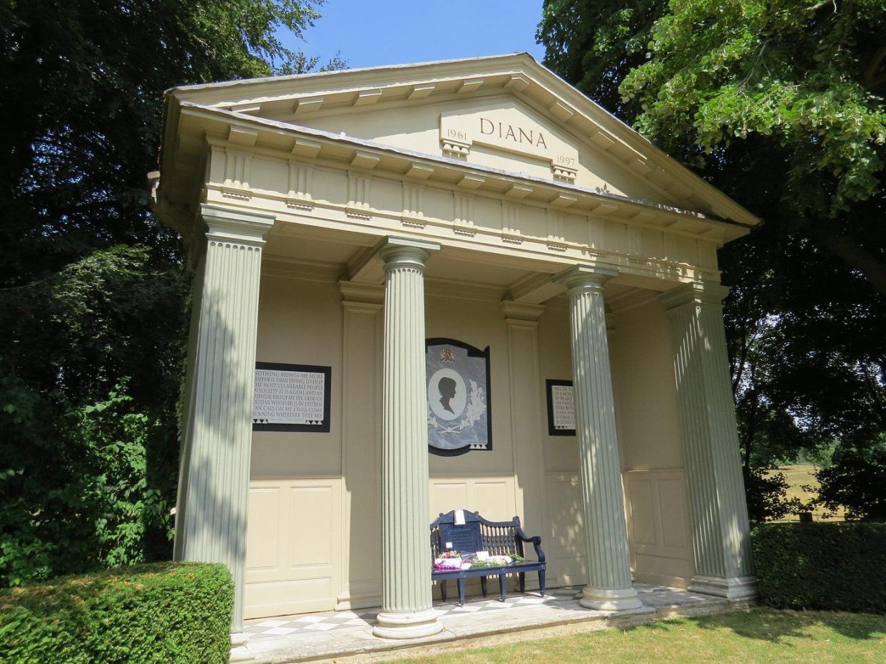 Princess Diana's tomb at the Althorp House, Althorp, England, a building with four columns surrounded by trees and bushes