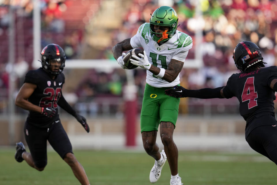 Oregon wide receiver Troy Franklin gets away from Stanford cornerback Zahran Manley, right, on his way to a touchdown during the second half of an NCAA college football game, Saturday, Sept. 30, 2023, in Stanford, Calif. (AP Photo/Godofredo A. Vásquez)