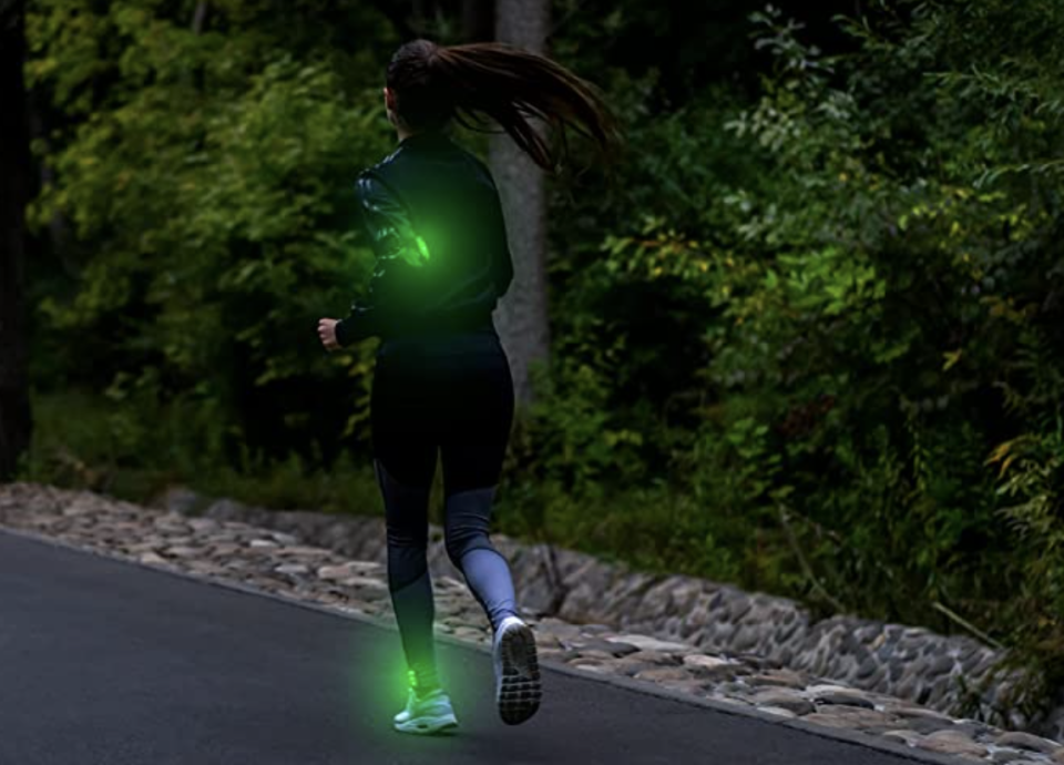 Girl running wearing LED lights.