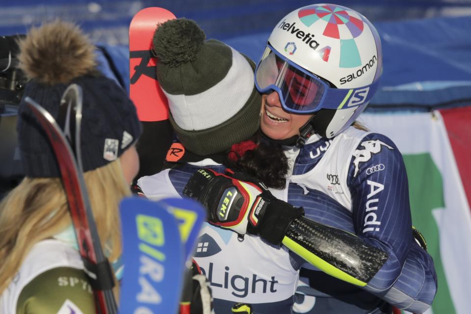 Italy's Marta Bassino, right, hugs second placed teammate Federica Brignone as she celebrates in the finish area after winning an alpine ski, women's World Cup giant slalom in Killington, Vt., Saturday, Nov. 30, 2019. (AP Photo/Charles Krupa)