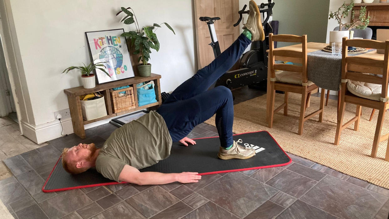  Man performing a bodyweight workout at home 