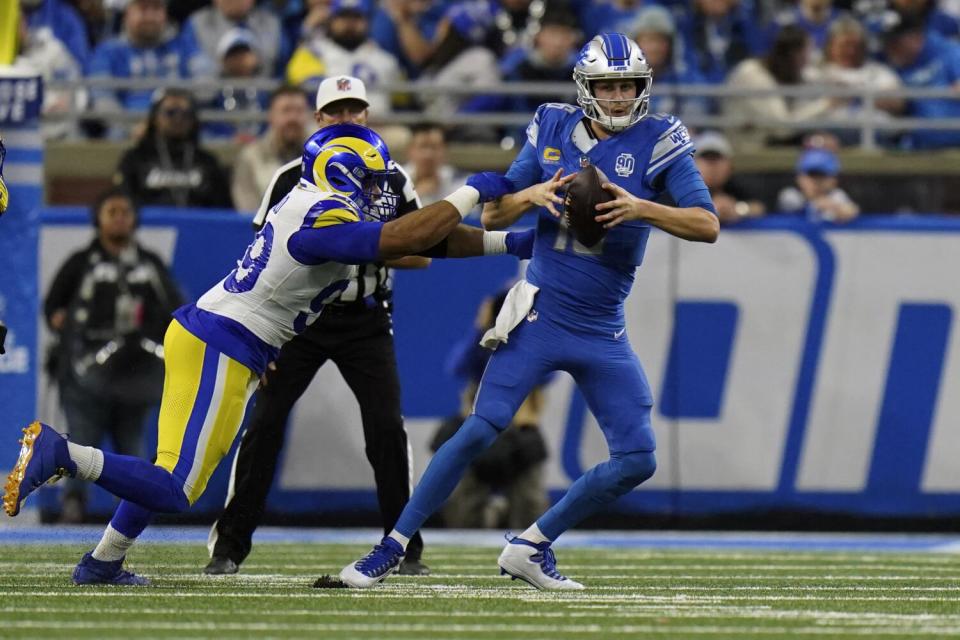 Detroit Lions quarterback Jared Goff (16) tries to avoid Rams defensive tackle Aaron Donald during a playoff game last season