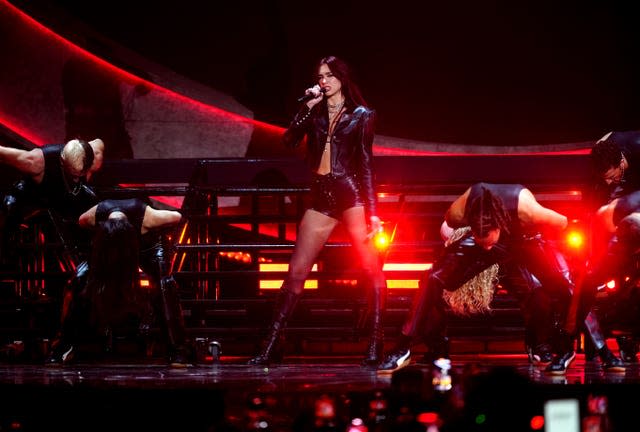 Dua Lipa performing at the Brit Awards in a black outfit