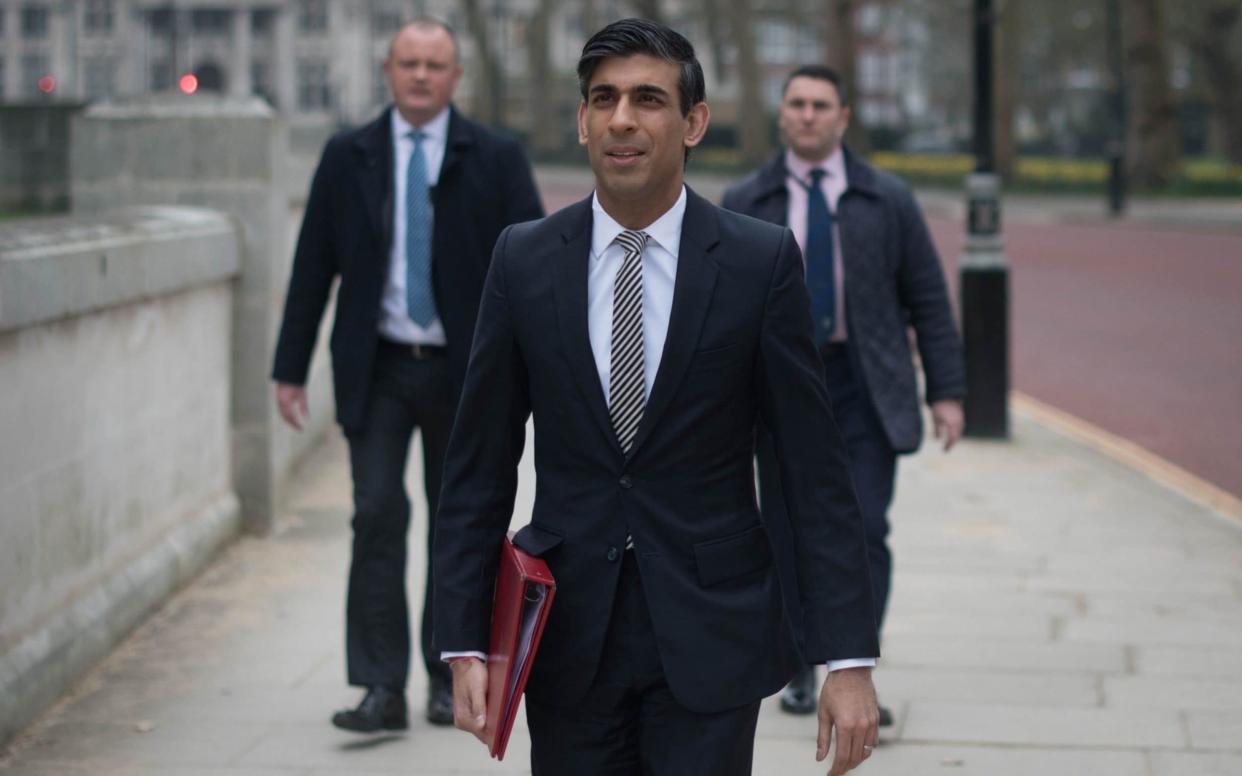 Rishi Sunak walks from the Treasury to No 11 Downing Street this morning - PA