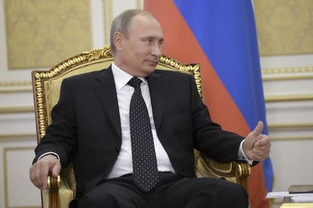 Russian President Vladimir Putin gestures during a meeting with his Kazakh counterpart Nursultan Nazarbayev in the city of Atyrau, September 30, 2014. REUTERS/Aleksey Nikolskyi/RIA Novosti/Kremlin