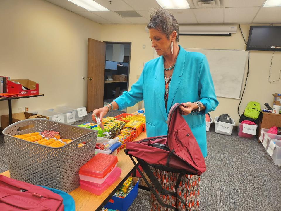Rainbow Room Coordinator Jenn Sugg packs a backpack full of school supplies. The Amarillo Rainbow Room is holding its annual Back to School Supply Drive, collecting supplies and community donations for 600 area children until Aug. 31.
