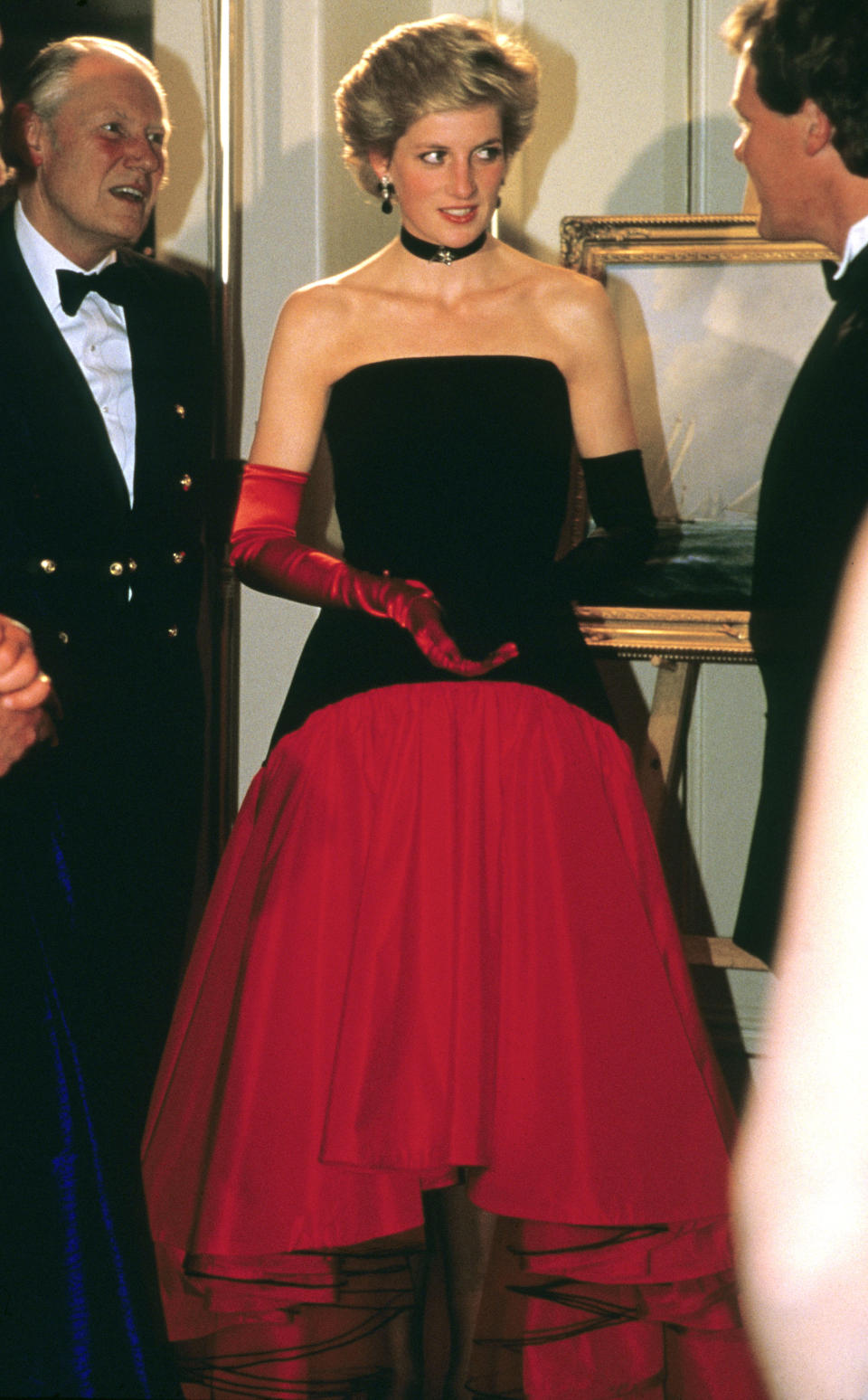 Princess Diana wore one red glove and one back glove while attending the America’s Cup Ball at the Grosvenor House hotel in London, on Sept. 1, 1986. The gloves complemented her Murray Arbeid flamenco dress. <em>(Photo by Anwar Hussein/Getty Images)</em>