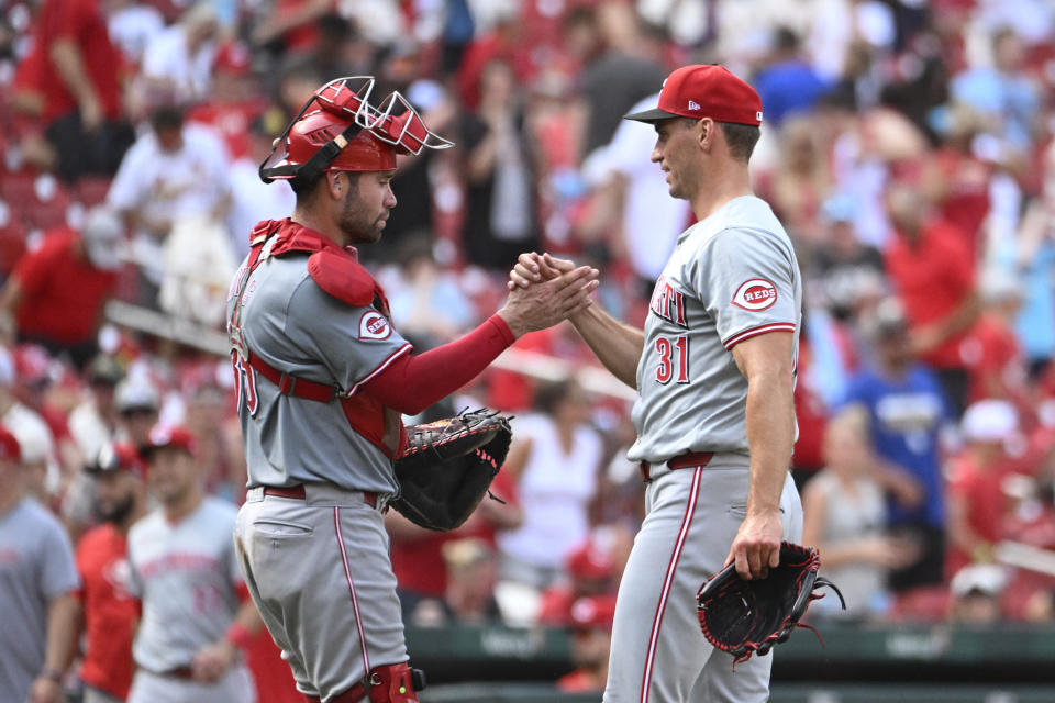 Cincinnati Reds catcher Austin Wynns, left, celebrates with teammate Brent Suter, right after defeating the St. Louis Cardinals in a baseball game, Saturday, June 29, 2024, in St. Louis. (AP Photo/Joe Puetz)