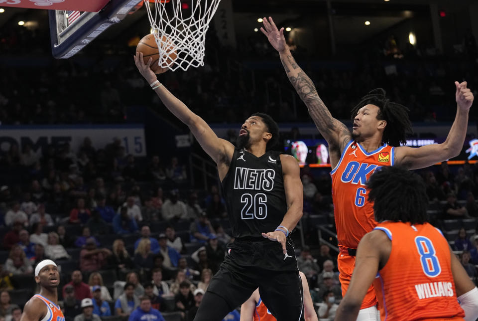 Brooklyn Nets guard Spencer Dinwiddie (26) goes to the basket in front of Oklahoma City Thunder forward Jaylin Williams (6) during the first half of an NBA basketball game Tuesday, March 14, 2023, in Oklahoma City. (AP Photo/Sue Ogrocki)