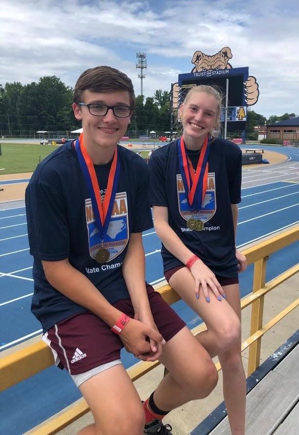 Gray (left) and fellow Maroon Devil pole vaulter Amelia Rogers after their 2021 1A state championships. Both athletes defended their titles as juniors Saturday.