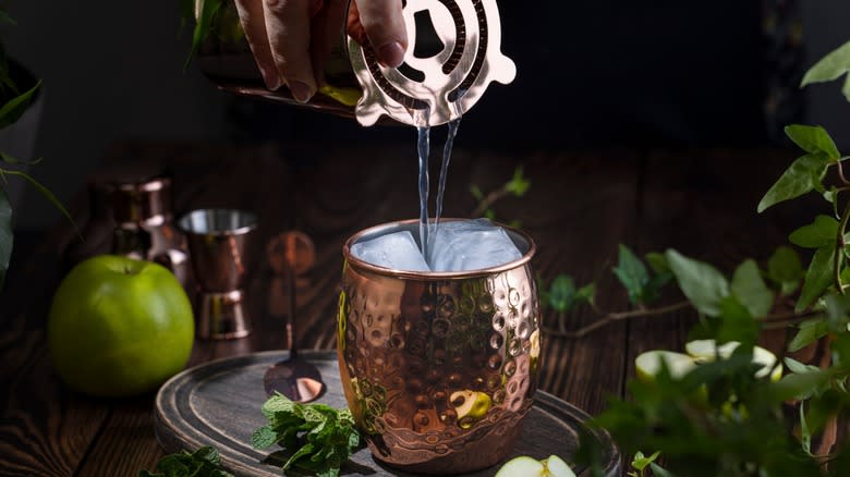 Pouring an Irish mule into a copper mug