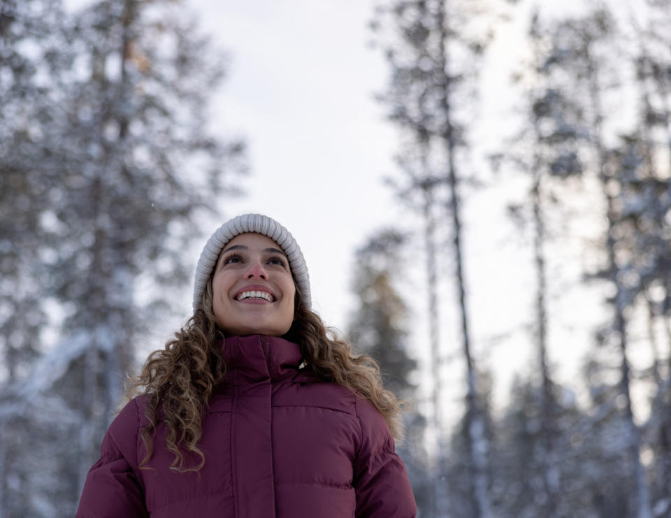 Happy woman outdoors enjoying the winter in Finland