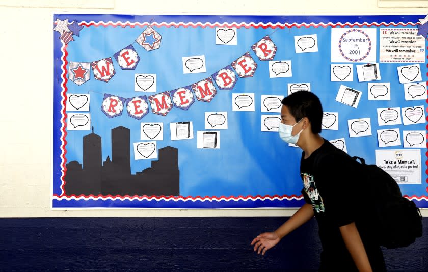 ARCADIA-CA-SEPTEMER 10, 2021: Middle school students place messages on a board commemorating 9/11 at First Avenue Middle School in Arcadia on Friday, September 10, 2021. (Christina House / Los Angeles Times)