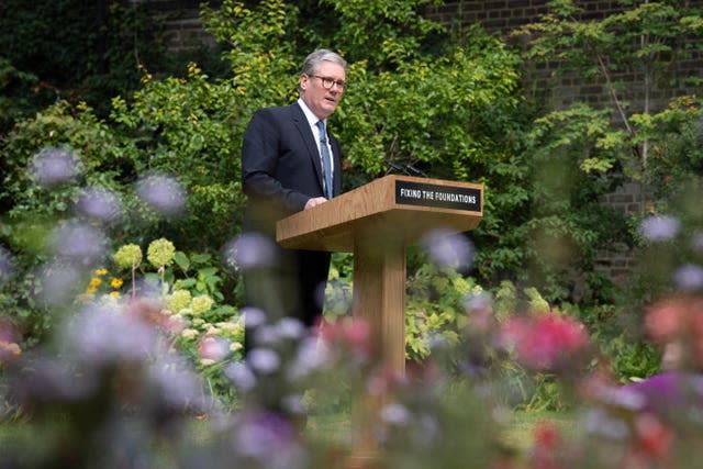 Sir Keir Starmer gives a speech in the rose garden of 10 Downing Street, standing at a lectern beraing the slogan "Fixing the Foundations"