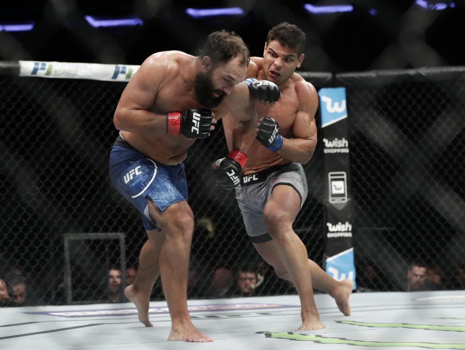 FILE- In this Nov. 4, 2017, file photo, Paulo Costa, of Brazil, punches Johny Hendricks, left, during a middleweight mixed martial arts bout at UFC 217 in New York. Israel Adesanya returns to the UFC cage this weekend to defend his middleweight title against Paulo Costa in the main event of UFC 253. (AP Photo/Frank Franklin II, File)