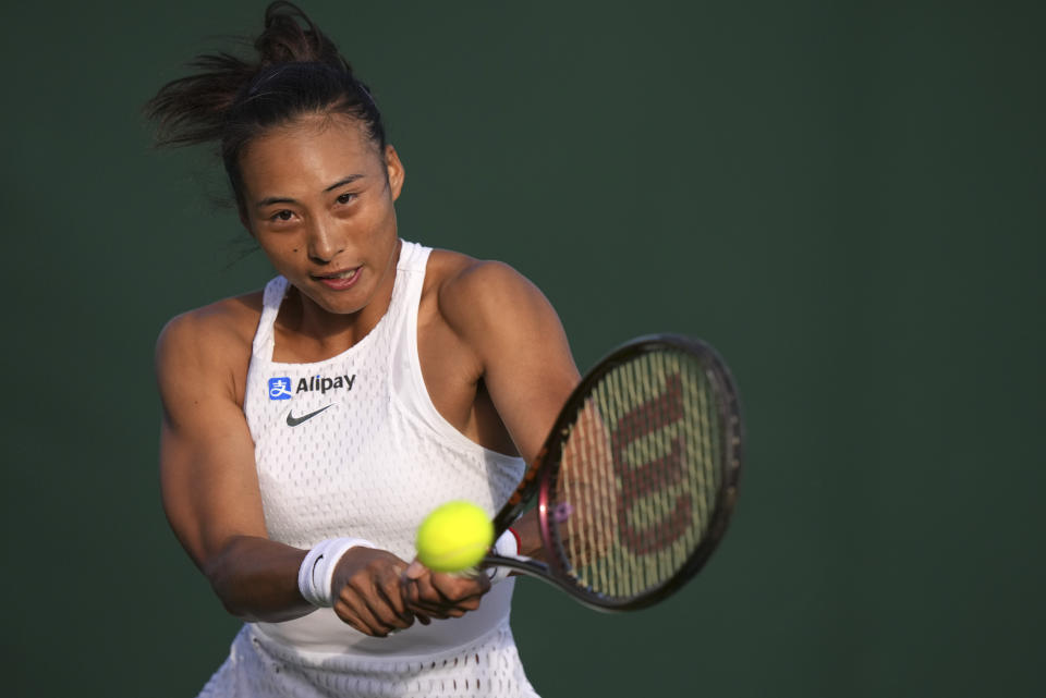 China's Zheng Qinwen returns to Czech Republic's Katerina Siniakova in a first round women's singles match on day one of the Wimbledon tennis championships in London, Monday, July 3, 2023. (AP Photo/Alberto Pezzali)